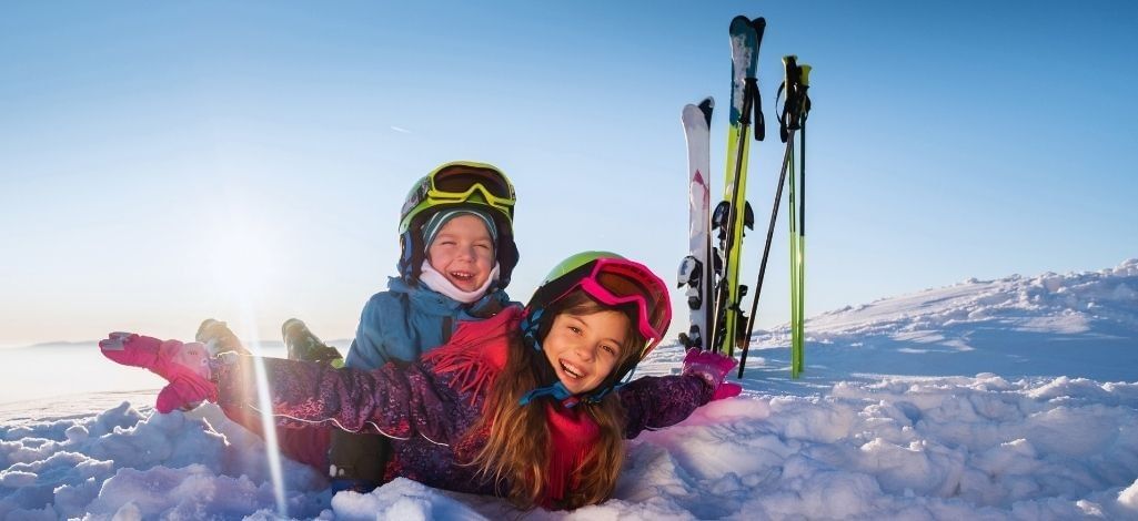 Kids playing in snow with skis