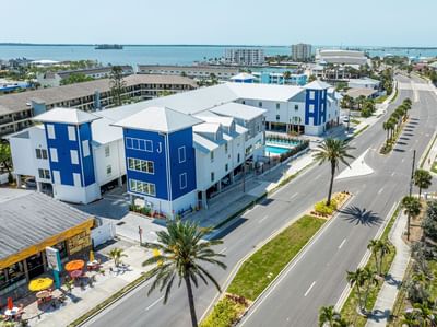 Aerial view of The J Hotel, one of the top hotels in Dunedin, FL, featuring the outdoor pool area and surrounding streets