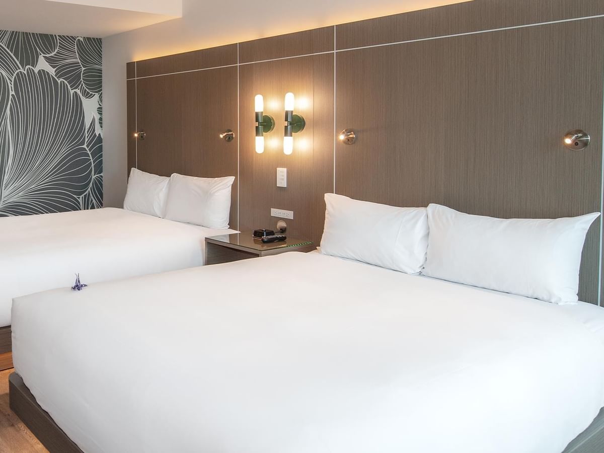 Two queen beds with white linens and decor.