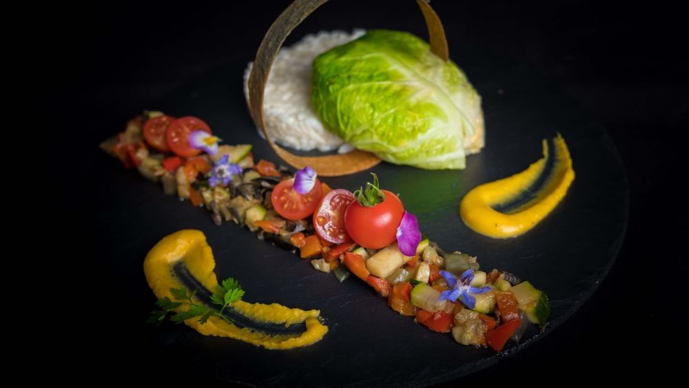 Gourmet vegetable dish with fresh cherry tomatoes placed by lettuce at Warwick Grand Place Brussels