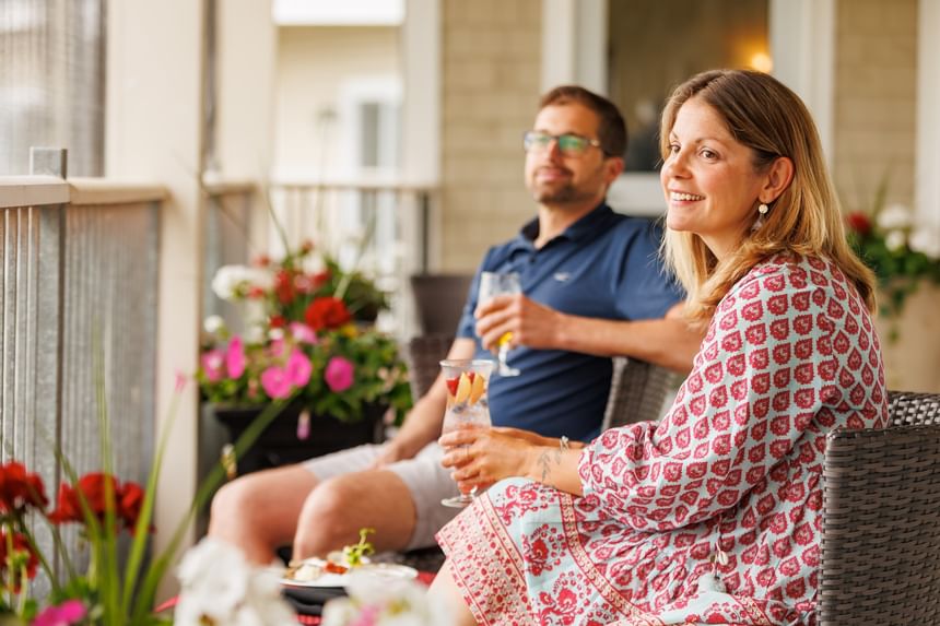 Couple enjoying drinks and fresh seafood on balcony for luxury accommodations PEI at Rodd Crowbush Golf & Beach Resort