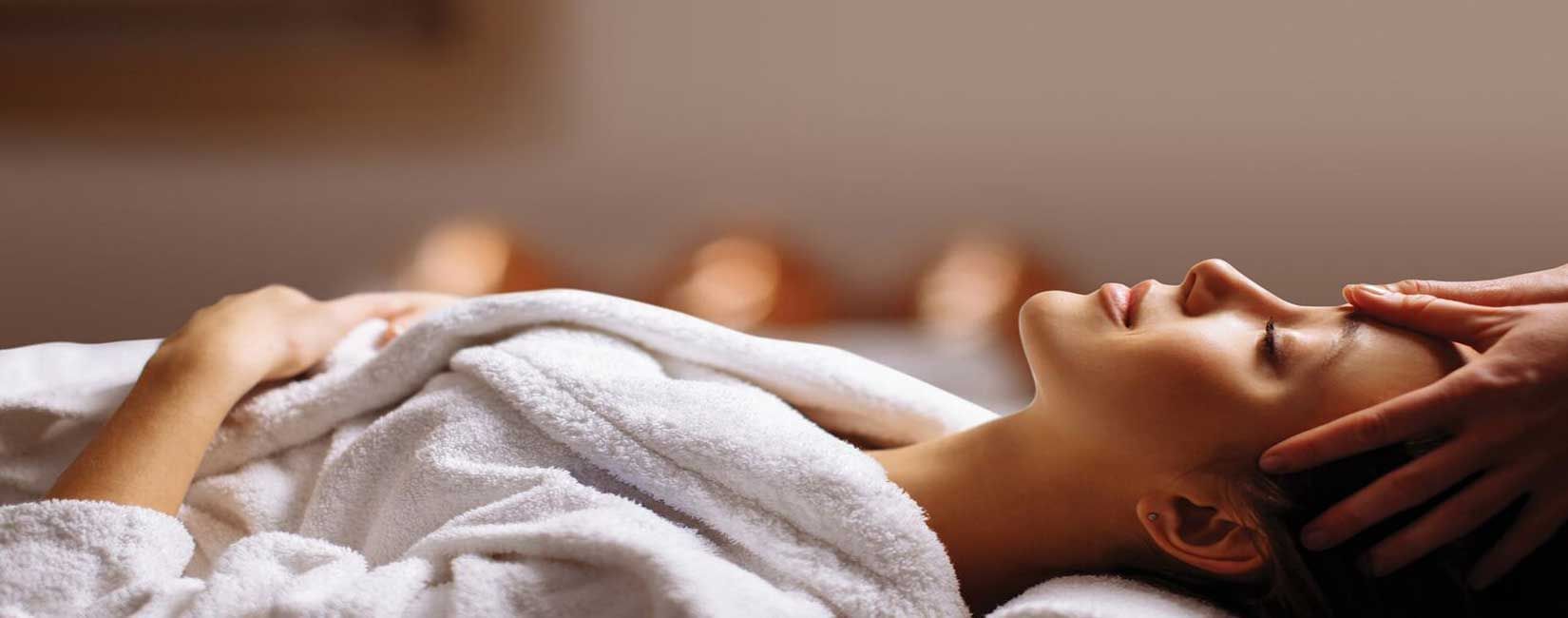 Lady receiving a head massage in Spa at Fullerton Bay Singapore
