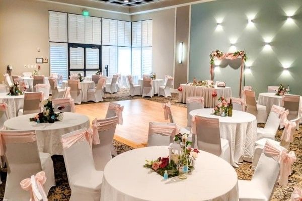 A setup for an engagement party at Rosen Inn Lake Buena Vista with round tables and floral centerpieces.