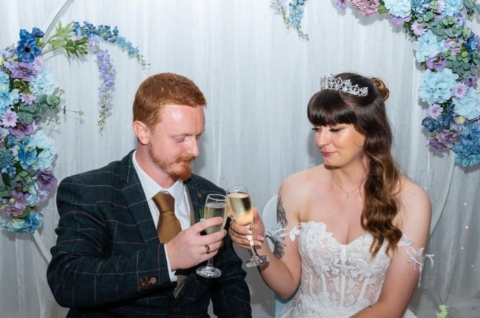 Bride and groom cheersing champagne at Villiers Hotel Buckingham