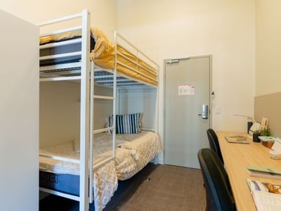 Bunk Room Twin Share with bunk beds and two desks at UniLodge Herston room.