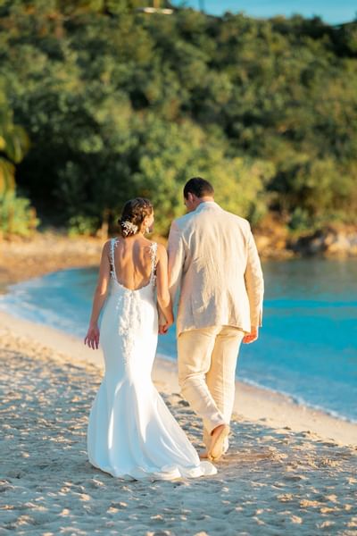 Bride & groom walking at Emerald Beach Resort, romantic moments at a St. Thomas resort for beach weddings on Lindbergh Bay