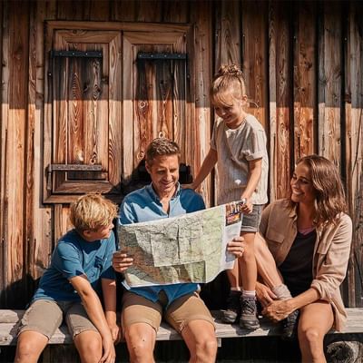A family reading a map at Falkensteiner Hotels