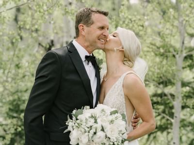 Wedded Couple posing outdoors in at Stein Eriksen Lodge