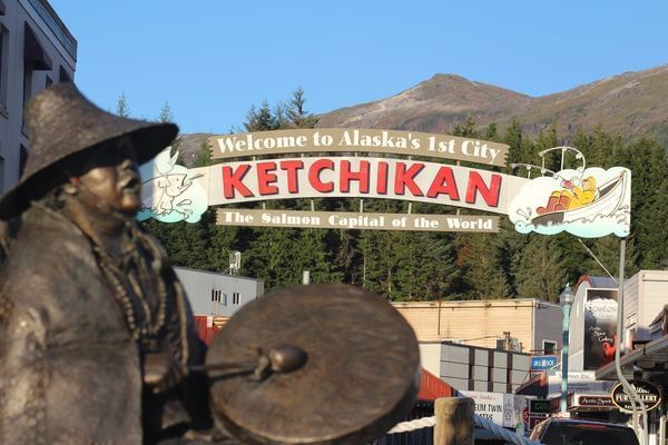 Welcome board of Ketchikan with mountains near Landing Hotel