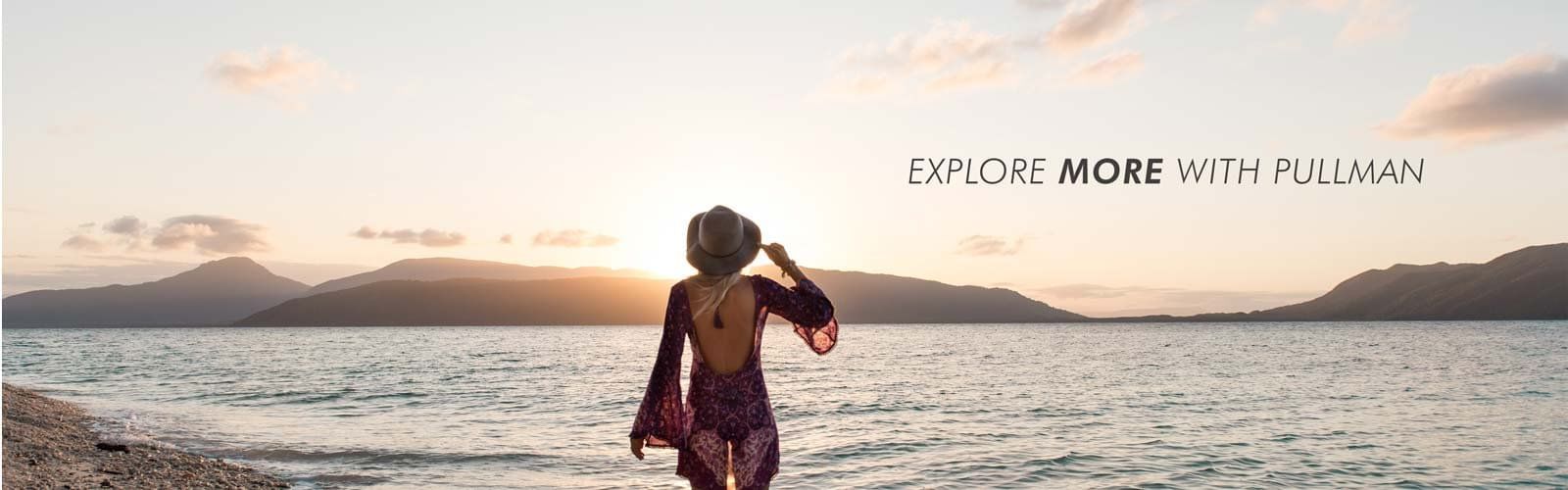A lady by the sea at sunset in a banner at Pullman Cairns