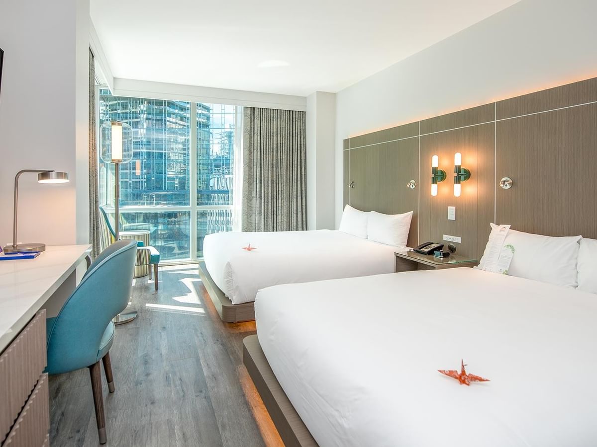 Accessible room with two queen beds and modern decor.