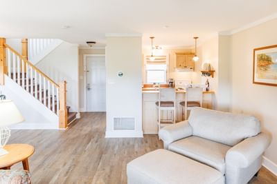Two-Bedroom Cottage featuring Sofa with kitchen, bar inside scenic PEI cottage unit at Rodd Crowbush Golf & Beach Resort