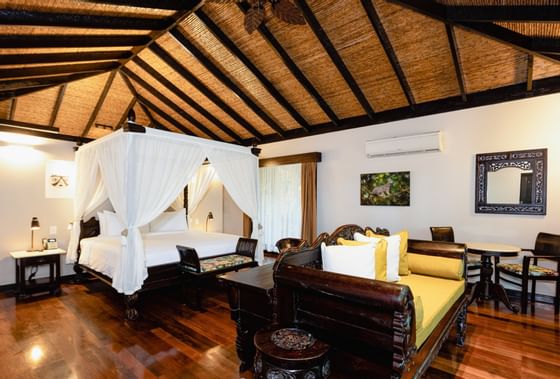 Bed & sofa in Casita Deluxe Garden view room at Rio Celeste