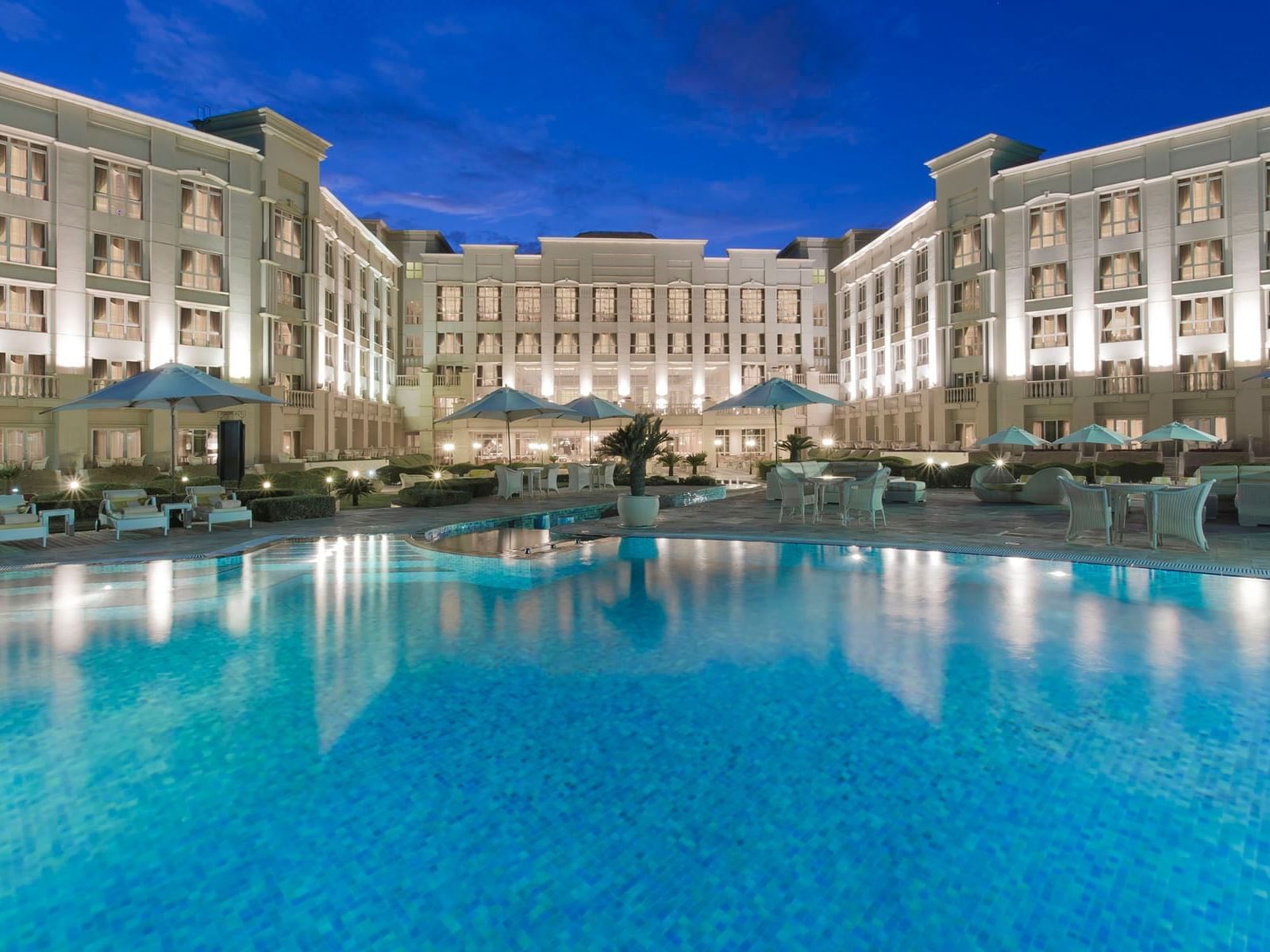 Outdoor family pool with pool loungers at The Regency Hotel