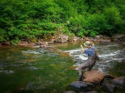 A man fly fishing in the river near Chatrium Niseko Japan