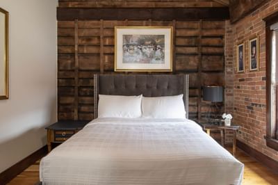 Cozy bed, wall paintings & nightstand in Apartment 402 at Retro Suites Hotel