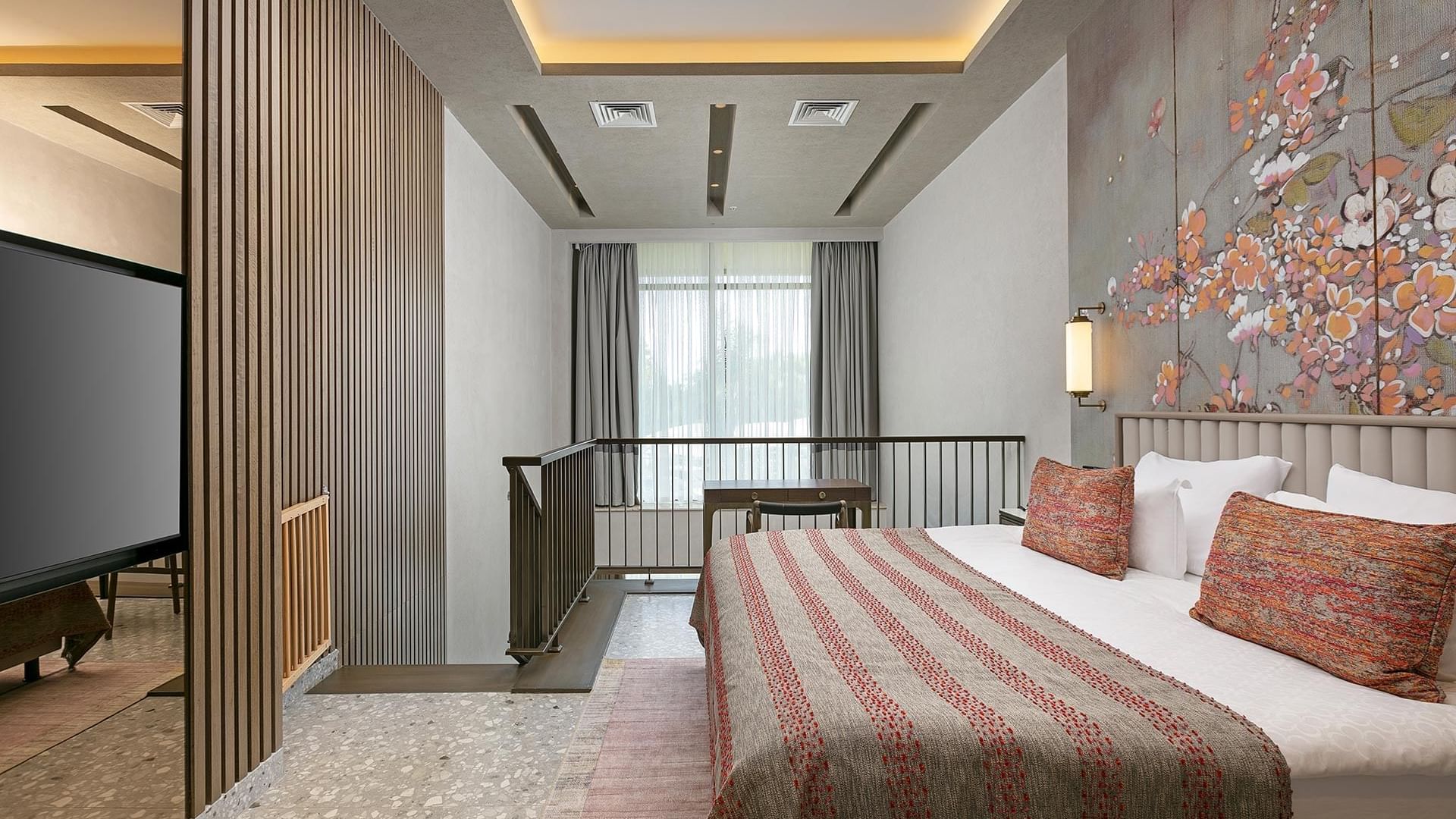 Cozy bed with floral wall art in Family Duplex at Cullinan Belek