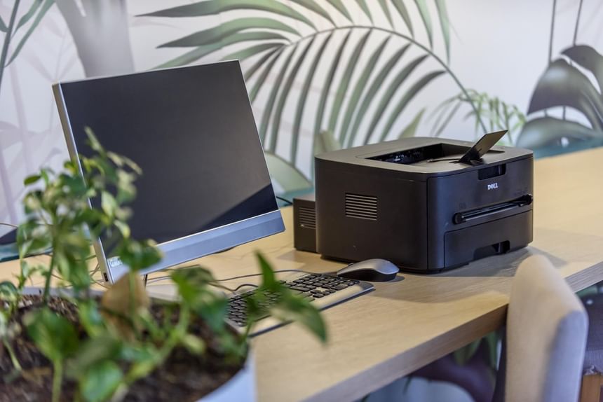 A printer and computer placed on a desk at Diez Hotel Categoría
