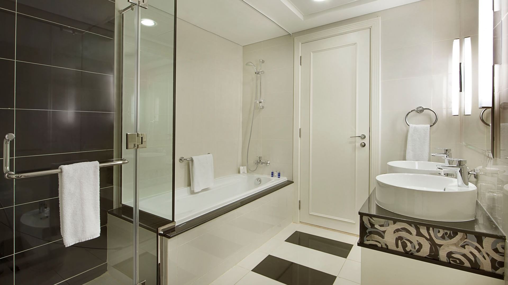 Bathroom vanity and shower area in Two Bedroom Suite at DAMAC Maison Dubai Mall Street