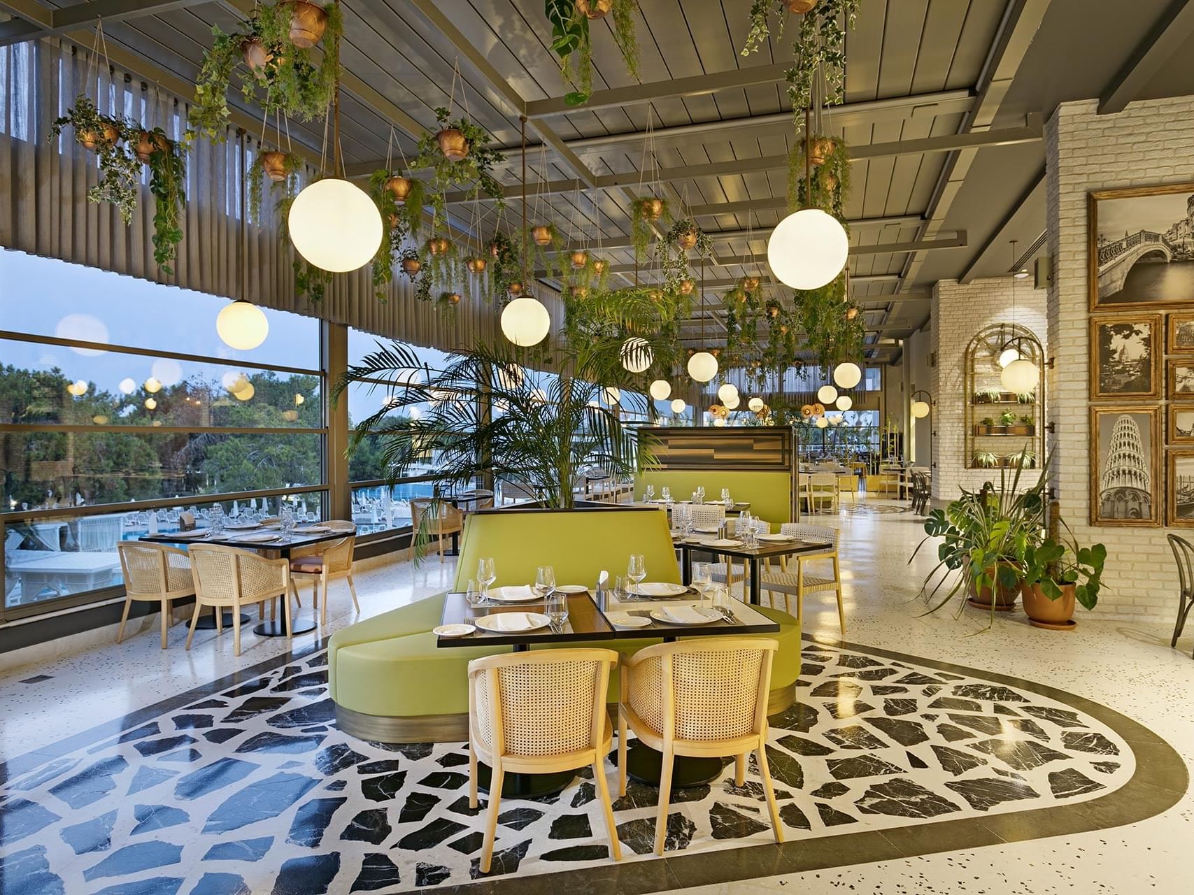 Dining tables arranged with wire knitted chairs in Pascarella Italian Restaurant at Titanic Deluxe Lara