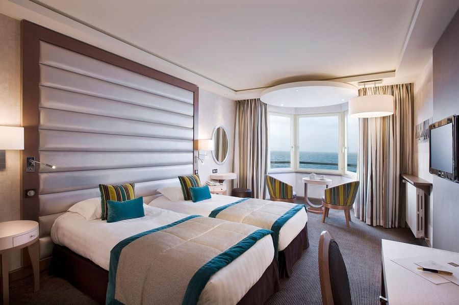 Two beds with a lounge area in Croisiere Grand Large Room at Le Grand Hôtel des Thermes