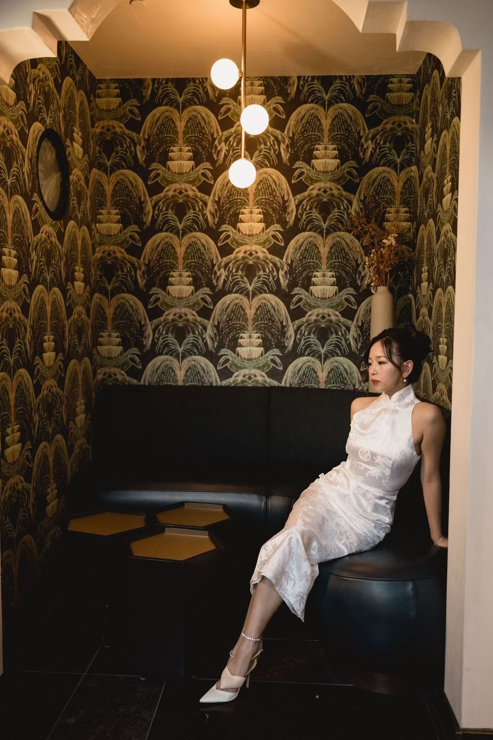 a bride sitting in the hidden alcove of the solarium