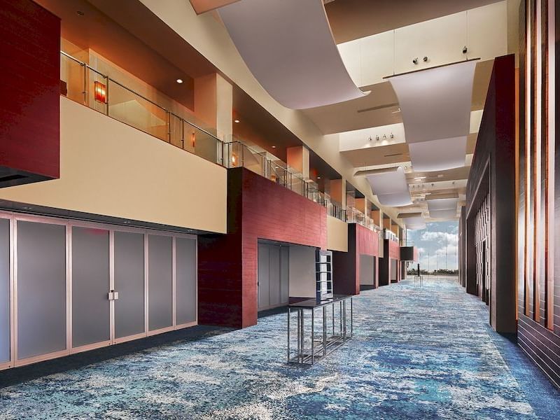 Grand Atlantic Atrium interior with large windows, and blue carpet at El Conquistador Resort