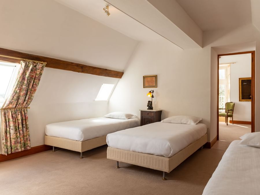 Superior Suite bedroom with twin beds at The Originals Hotels
