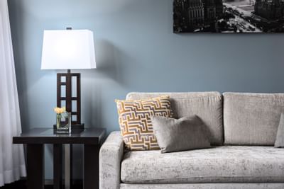 Living room with sofa and lamp at Embassy Hotel & Suites Ottawa