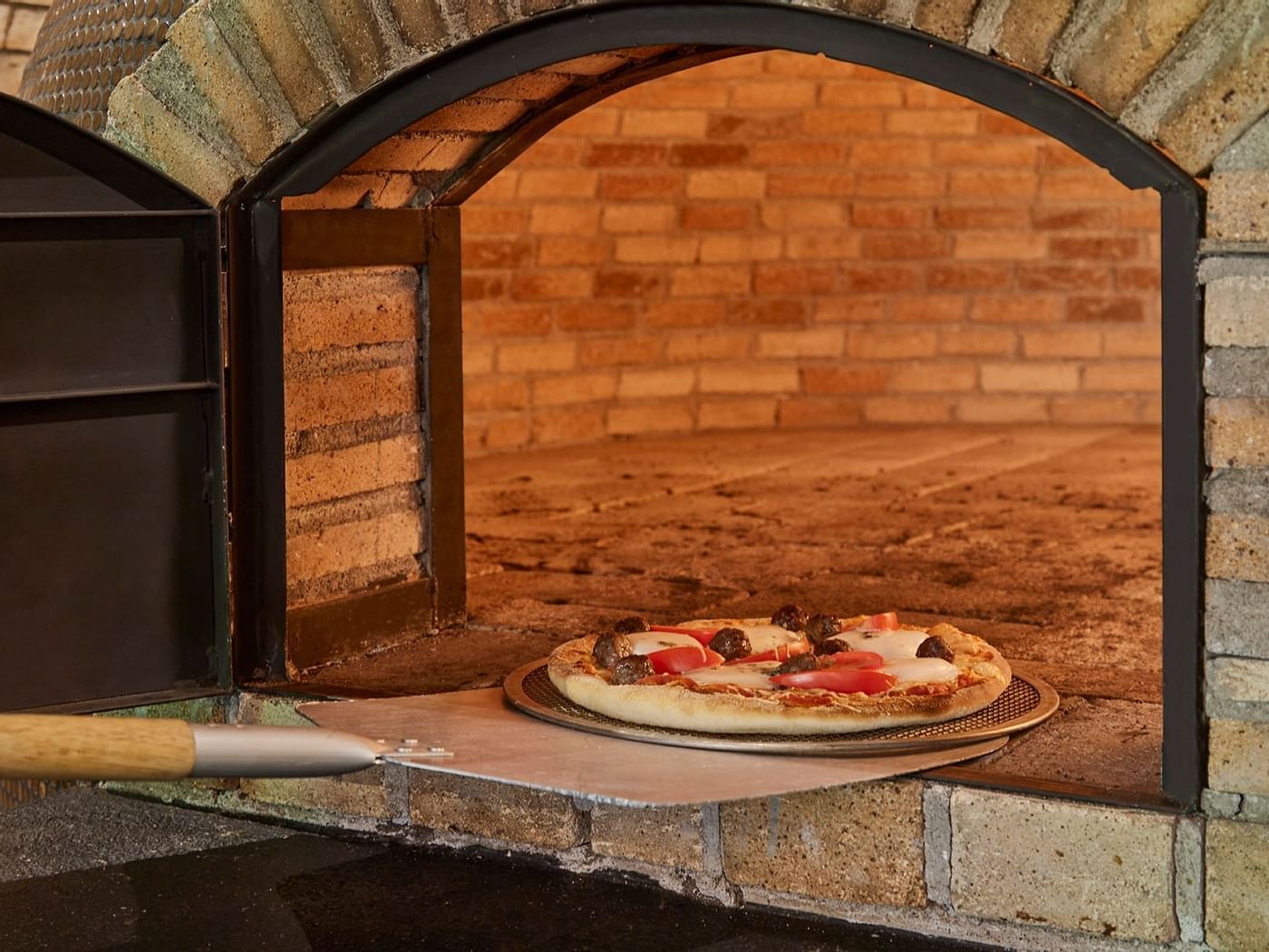 A pizza pulled from the oven at Fiesta Americana Hotels