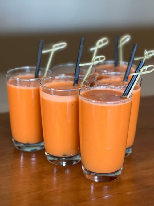 Glasses of orange juice served on a wooden table at Hotel Eldorado