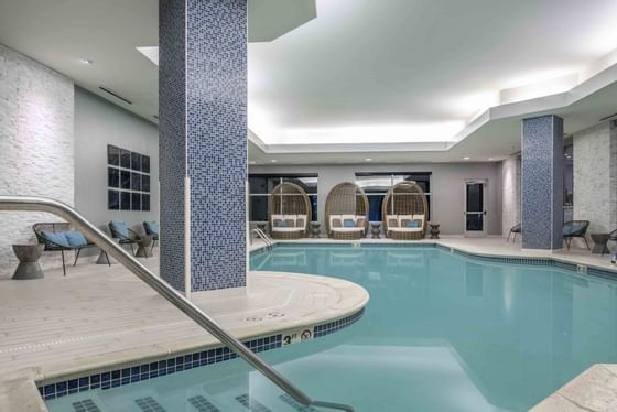 indoor pool with lounge chairs