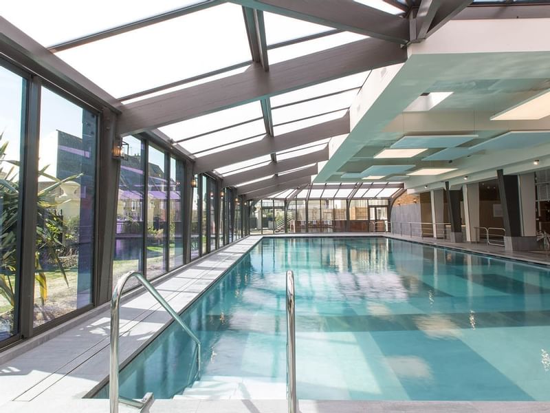 Indoor pool with outdoor view at Le Grand Hôtel des Thermes
