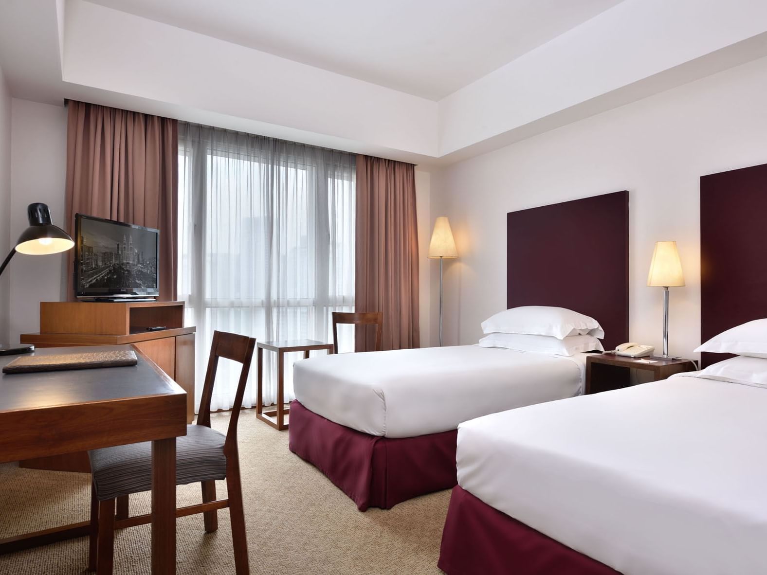 Twin beds & working desk in Premium room at Federal Hotels 