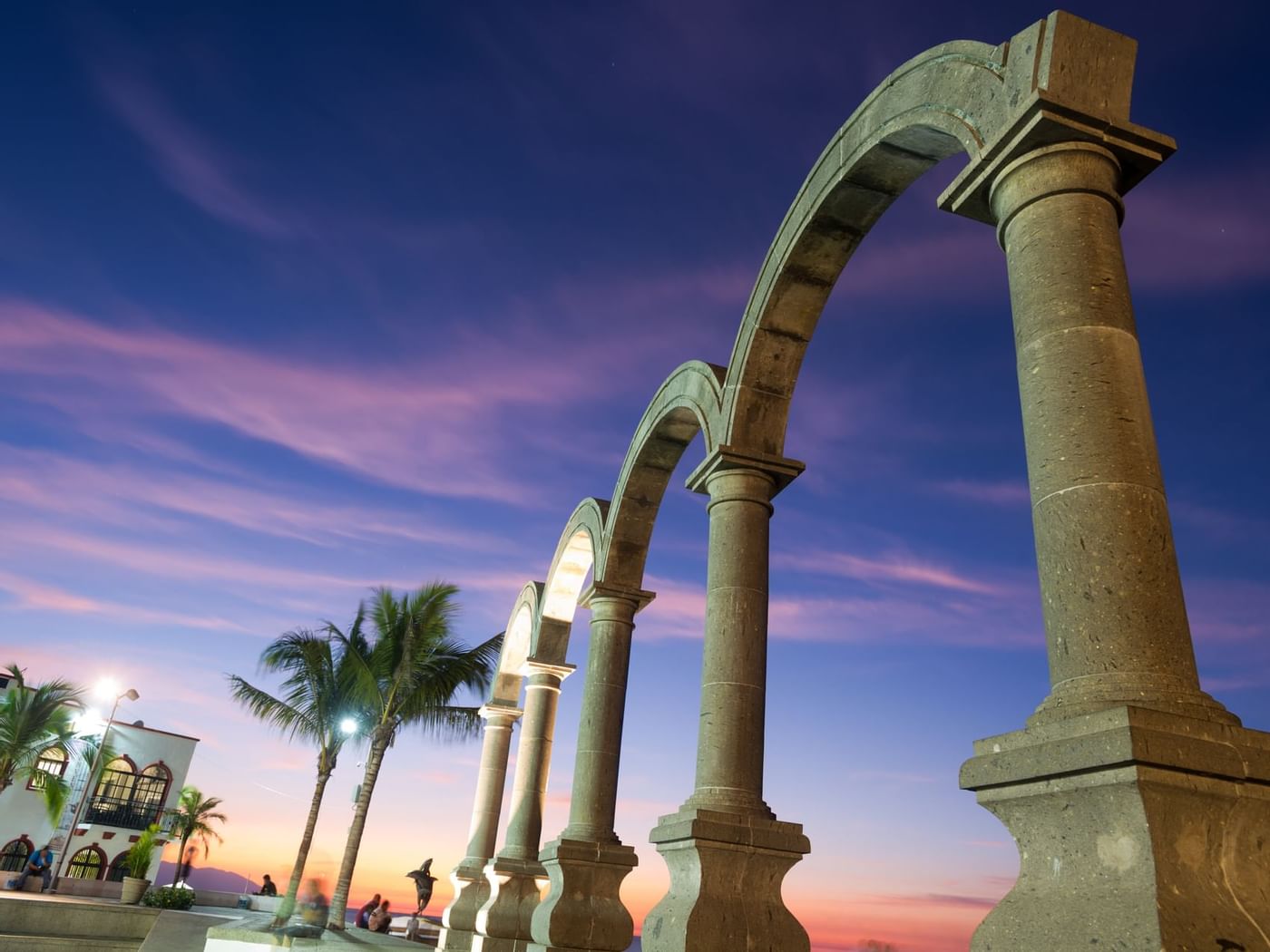 Arches of El Malecón at sunset near Fiesta Americana Hotels