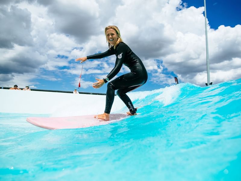 Lady surfing in UrbnSurf Sydney near Pullman Sydney Olympic Park