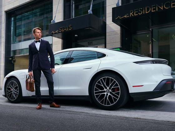 A man standing beside the car by the entrance at ReStays Ottawa