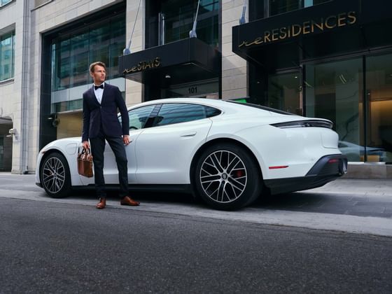 A man standing beside the car by the entrance at ReStays Ottawa
