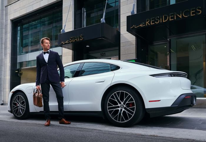 A man standing beside the car by the entrance at ReStays Ottawa