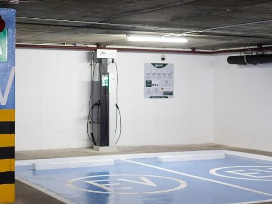 An electric car charging station in a parking garage, providing convenient and eco-friendly charging options