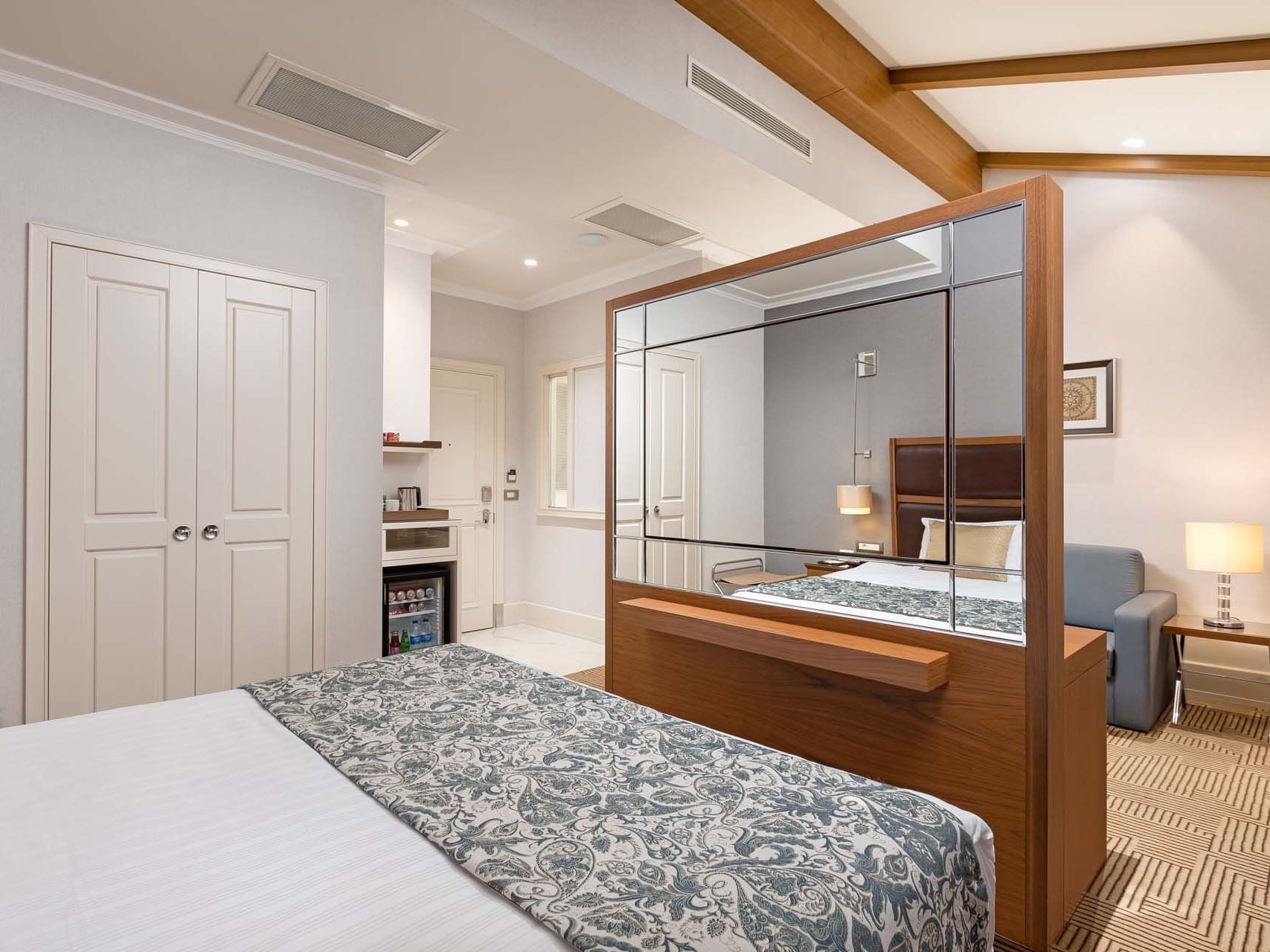 Comfy bed and mirror in Executive Room at Titanic City Taksim
