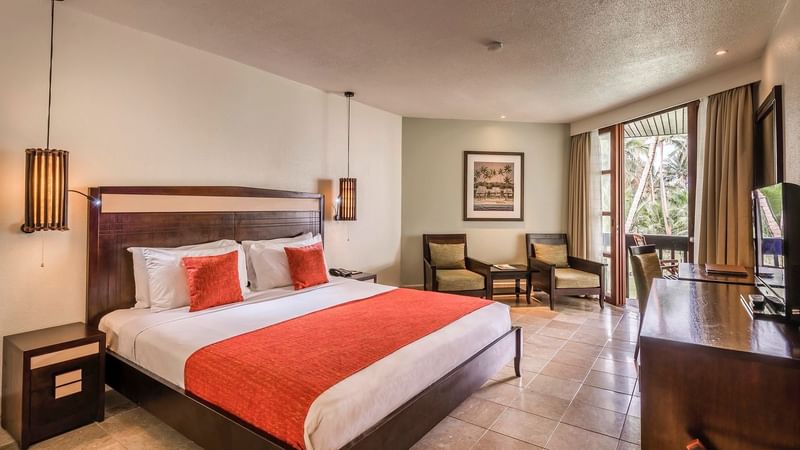 Interior of the bedroom in Warwick Deluxe room at Warwick Fiji
