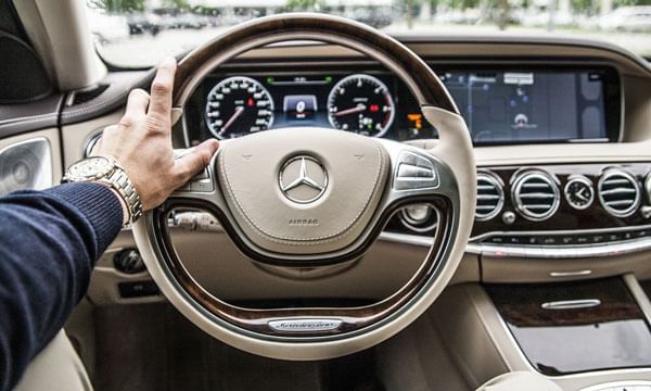 Driver's hand on a steering wheel near Lake Buena Vista Resort Village & Spa