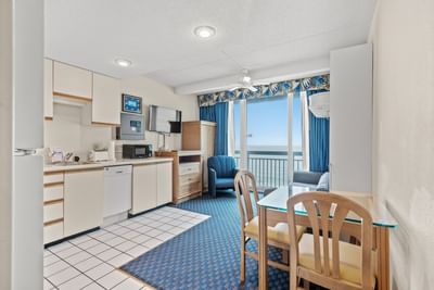 Kitchen area with dining table in Grand Two Bedroom at The Yachtsman Resort