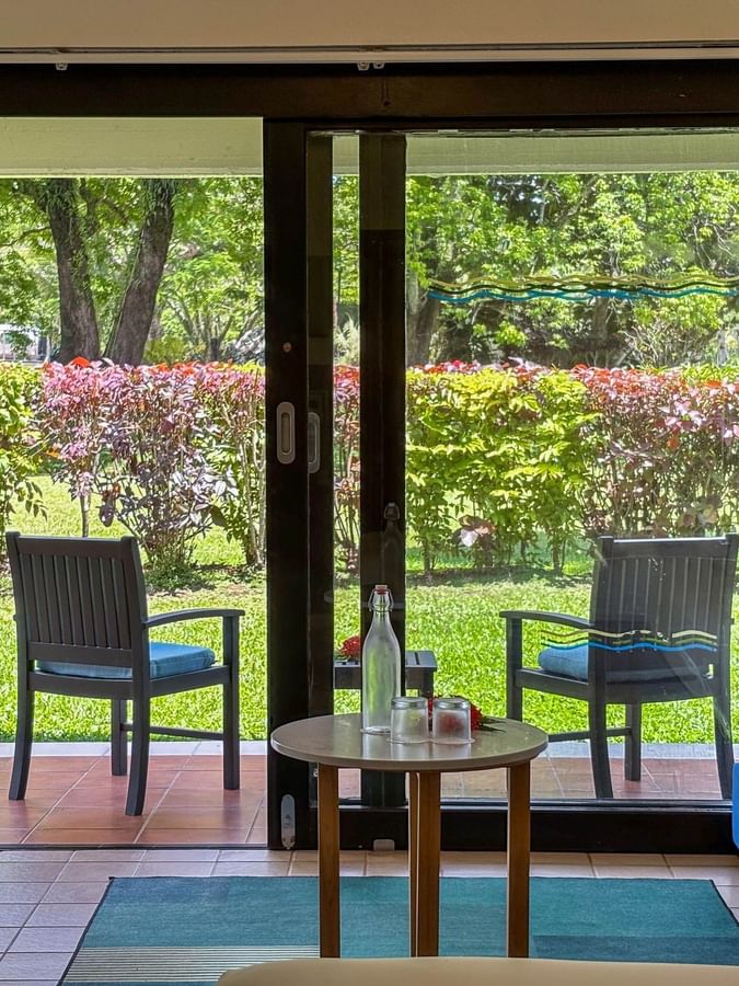 Superior Garden View Room with outdoor seating and lush garden view at The Naviti Resort, Korolevu.