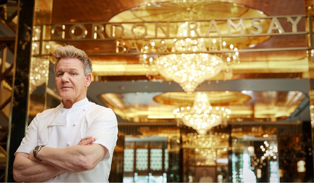 Chef in white uniform with crossed arms in Gordon Ramsay’s restaurant at Sunway Hotels & Resorts