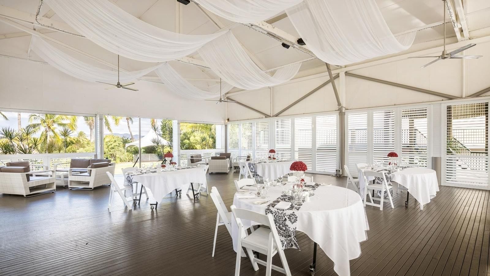 Plantation Deck featuring set tables, decorative centerpieces and flowing drapes at Mercure Hotel Townsville