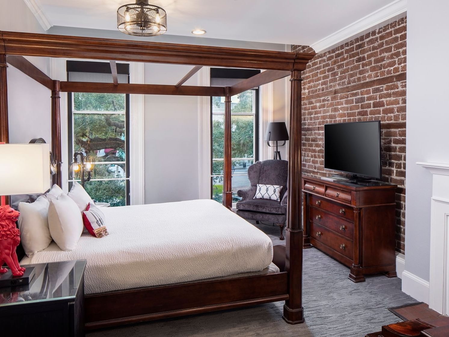 TV and couch-facing bed in Historic City View Room with One King at River Street Inn