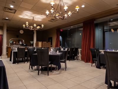 Elegantly set dining room with chandeliers at Carriage House Hotel & Conference Centre