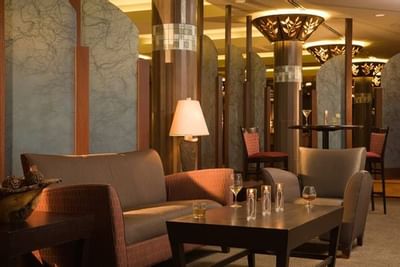 fancy lounge area with table and sofa chairs